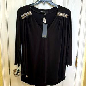 Women’s size large dress top. Black with silver stones near shoulders.